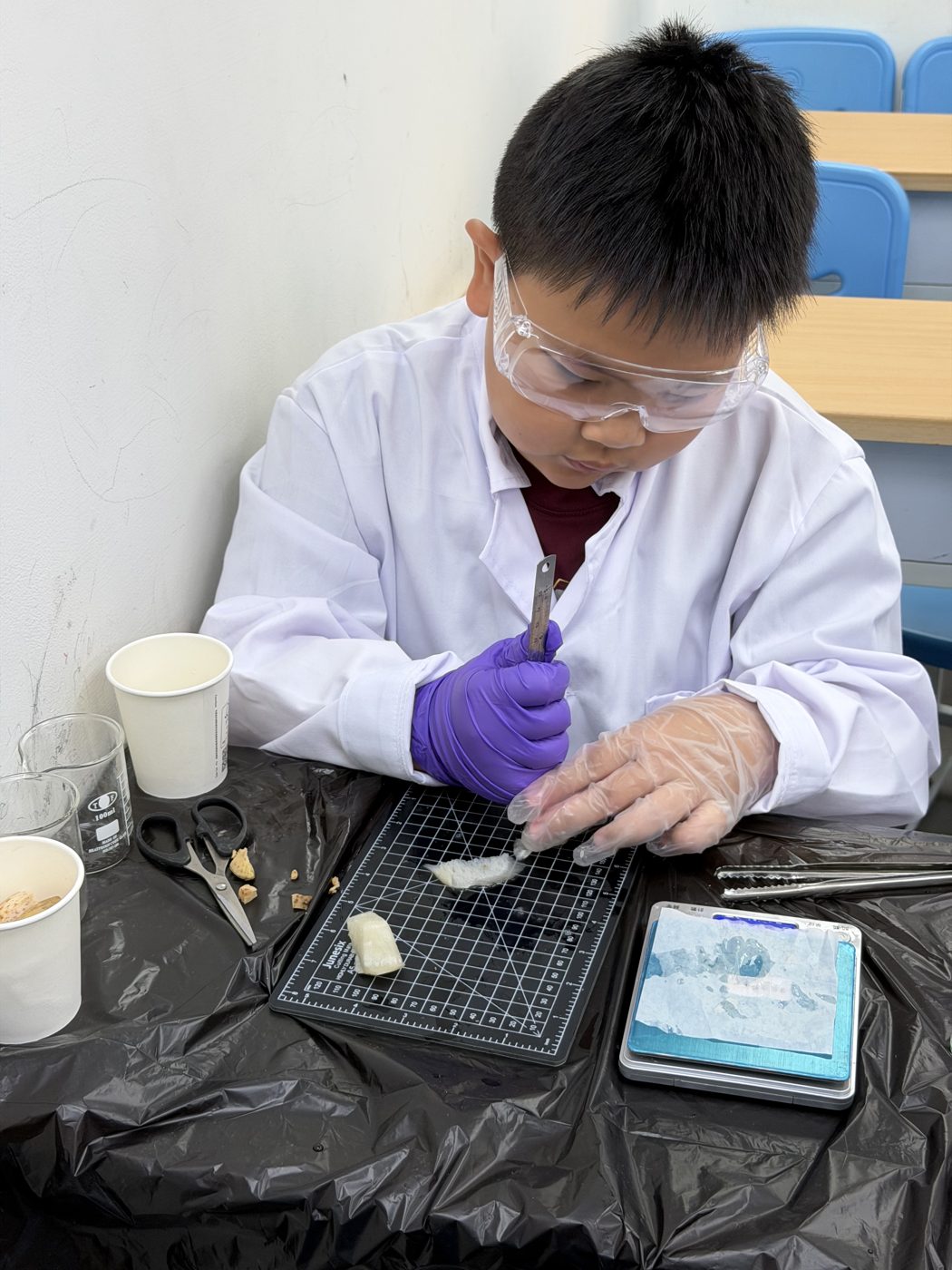 穿實驗衣戴手套做實驗的男孩